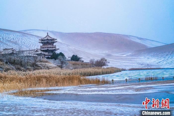 2021年11月28日，雪落鳴沙山月牙泉景區(qū)?！⊥醣筱y 攝