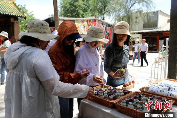 圖為民眾挑選手工藝產(chǎn)品?！⊙Φ?攝